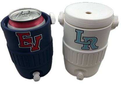 Two insulated can coolers shown on a plain white background, one in white with a light blue and gray lettering design, and one in dark navy with a red and gray lettering design. Both are shown from different angles to display the top opening and side profile.